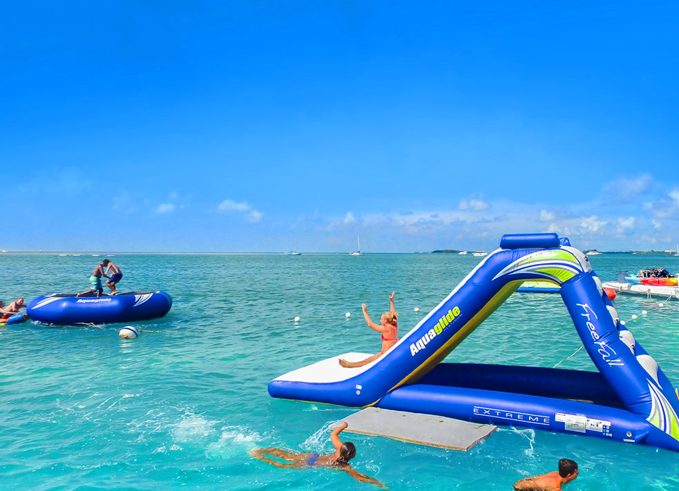 People playing on water toys in the ocean