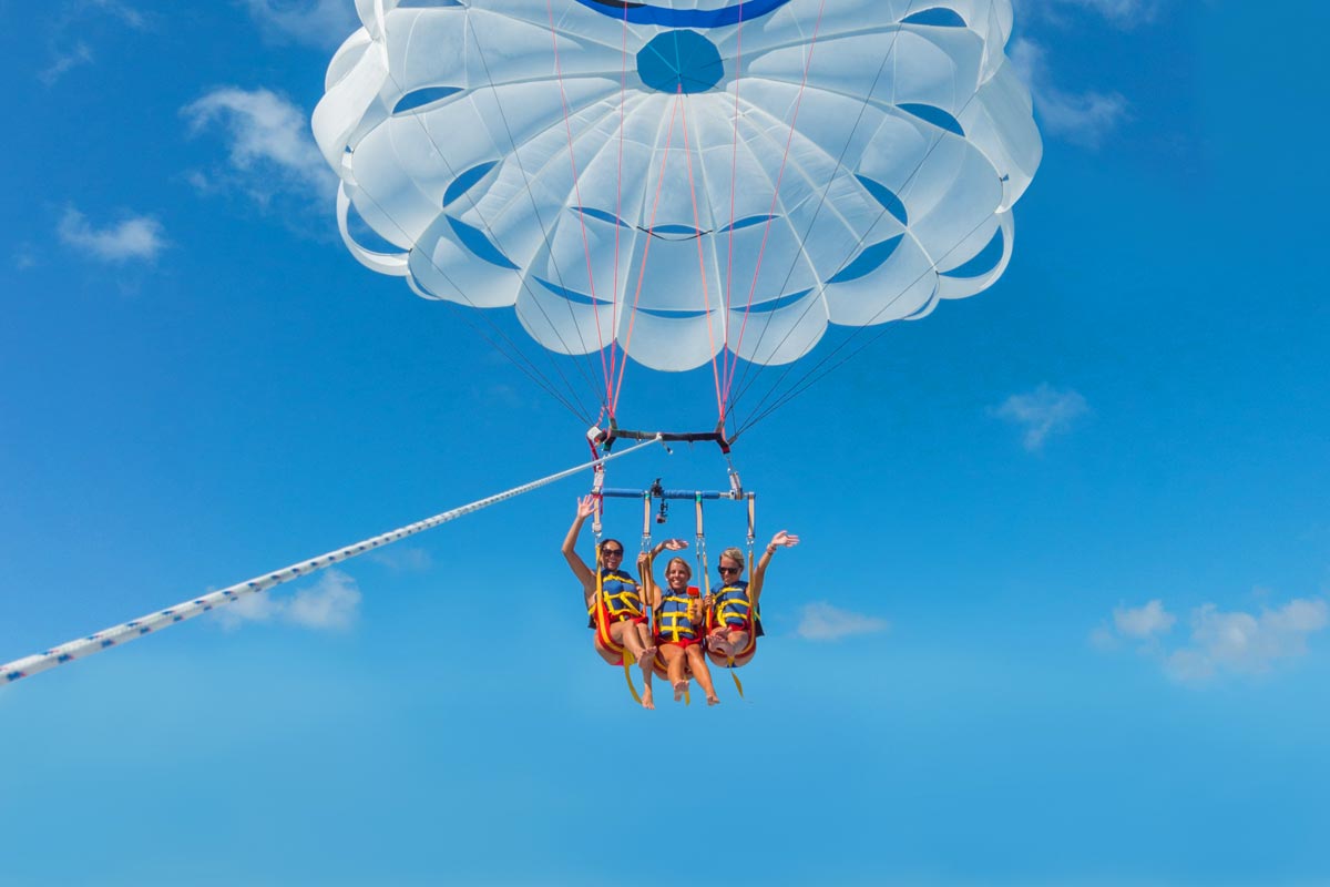3 people parasailing above the ocean in Key West